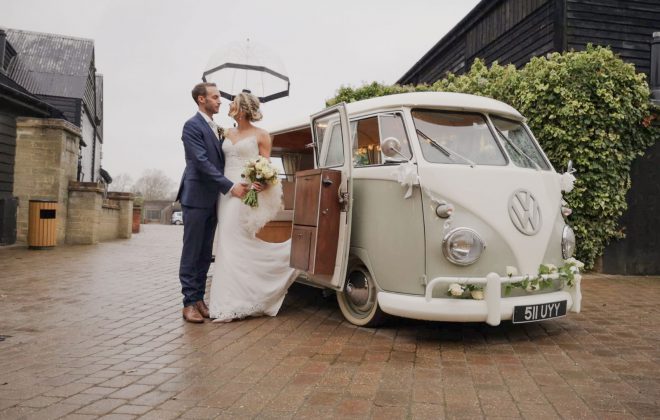 bride and groom standing next to VW split screen camper on their wedding day
