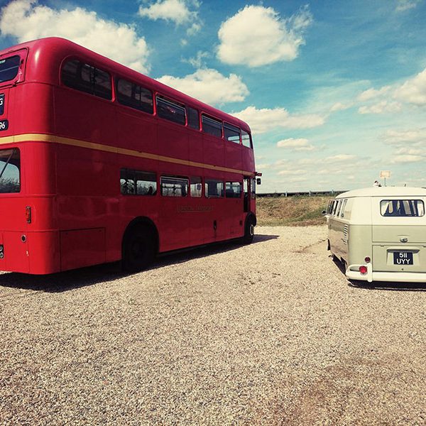 1961 VW split screen campervan next to red London bus for wedding