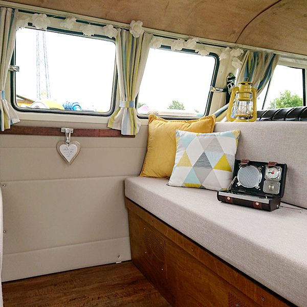 Interior of vintage VW campervan with cushions and retro radio