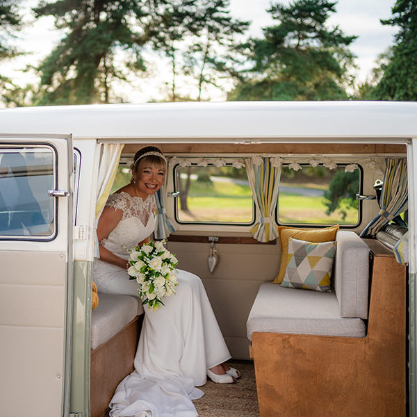 Bride sitting in VW splitscreen campervan