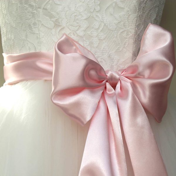 baby pink satin sash worn around the waist with a wedding dress
